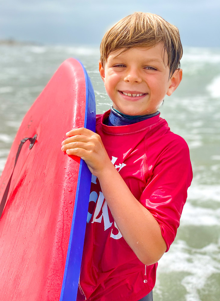 Smiling camper at Corky Carroll's Boogie Board Camp in Huntington Beach